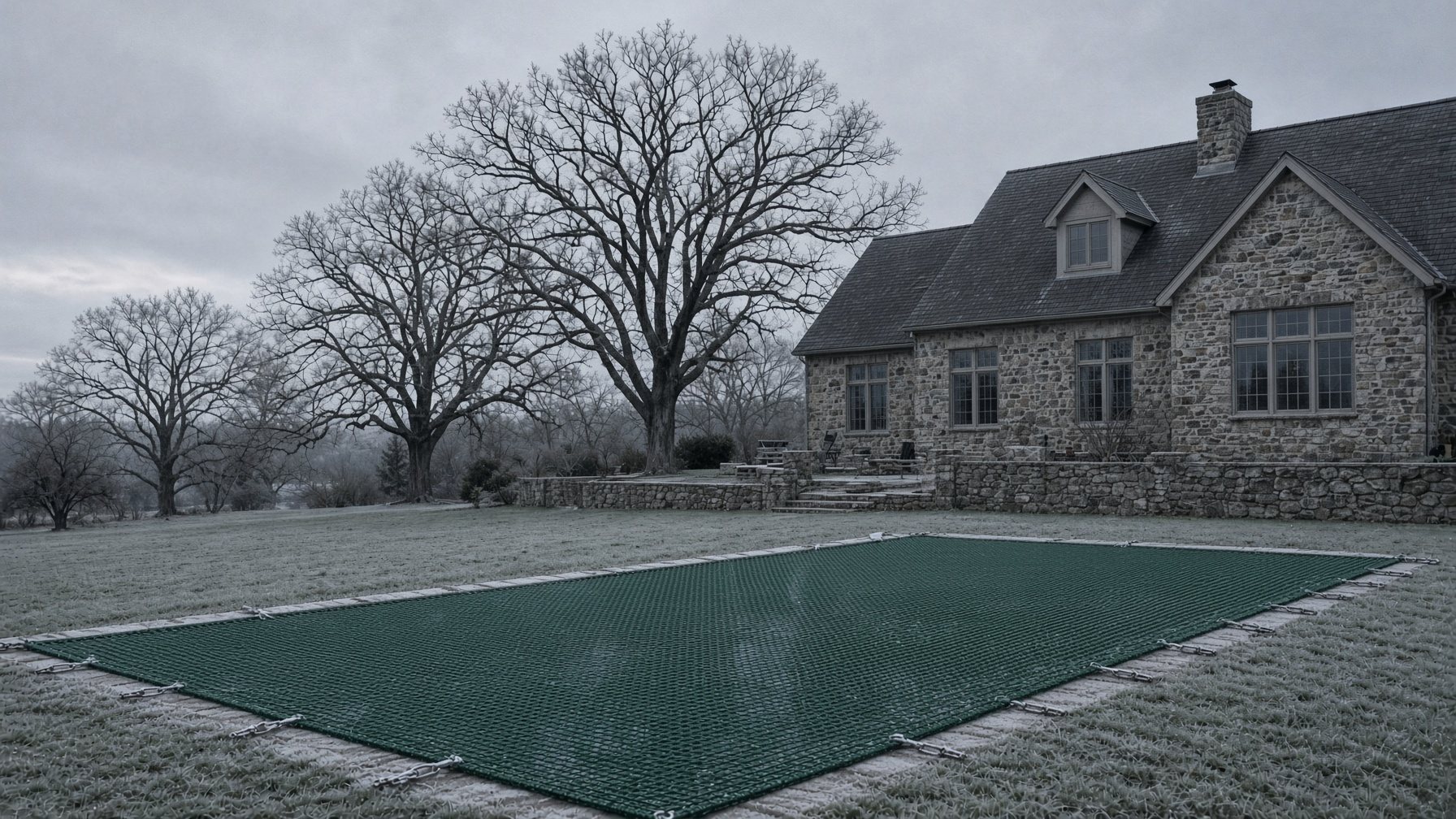 Frost on a mesh safety cover at a stone house in winter